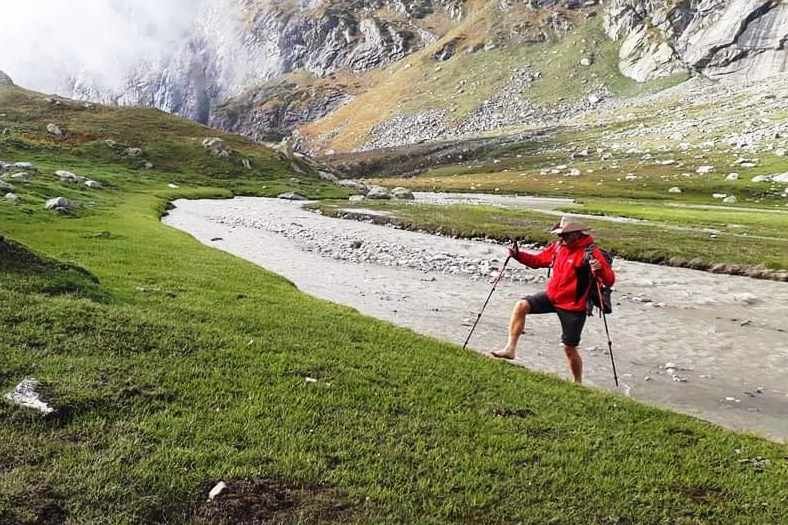 Man crossed water stream and hiking